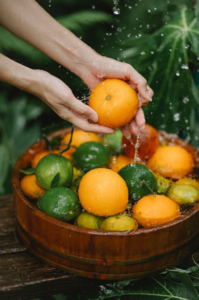 pexels-photo-5946051 Crop Woman Washing Fresh Fruits In Bowl